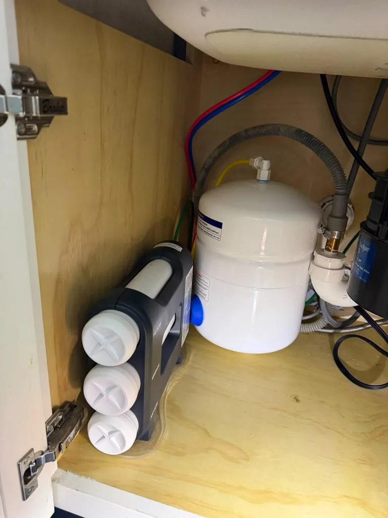 Reverse osmosis water filtration system installed under a kitchen sink